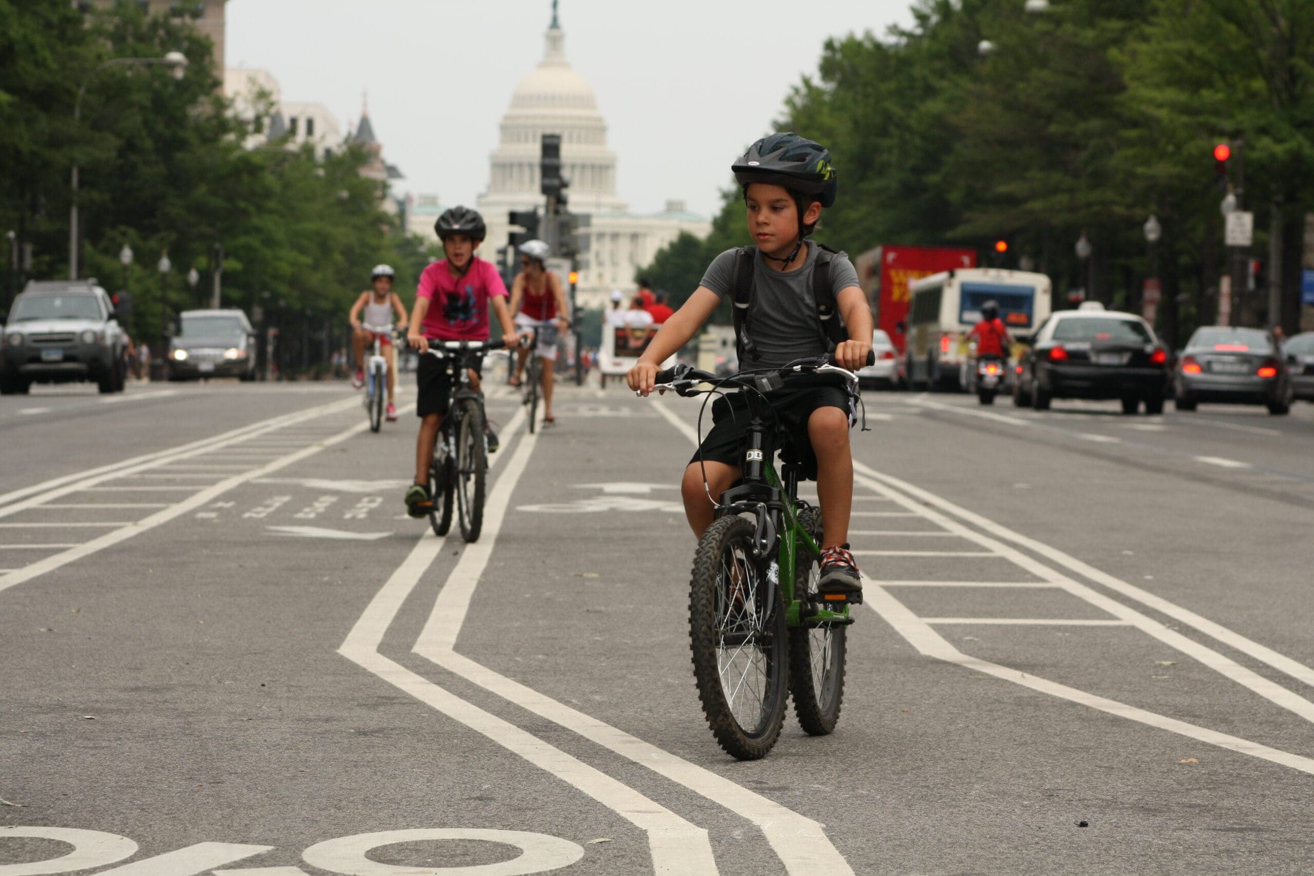 young-cyclists-dc-capitol-bike-lane-cars-scaled